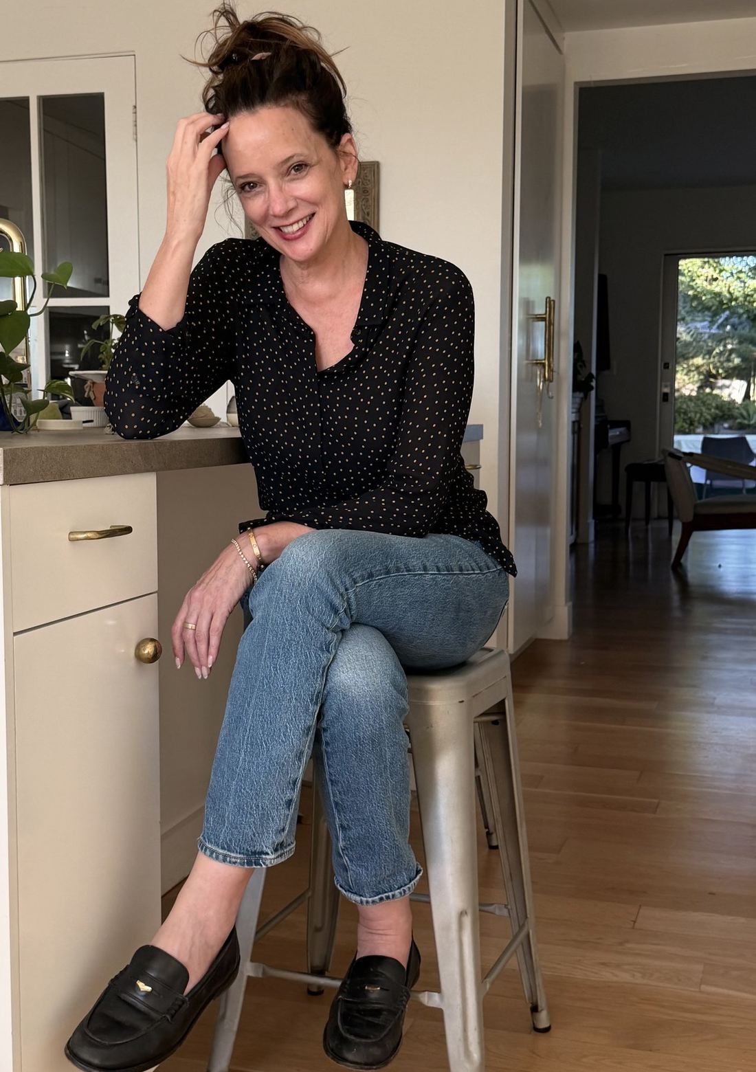 Alexis Hall sitting on a stool at her kitchen counter